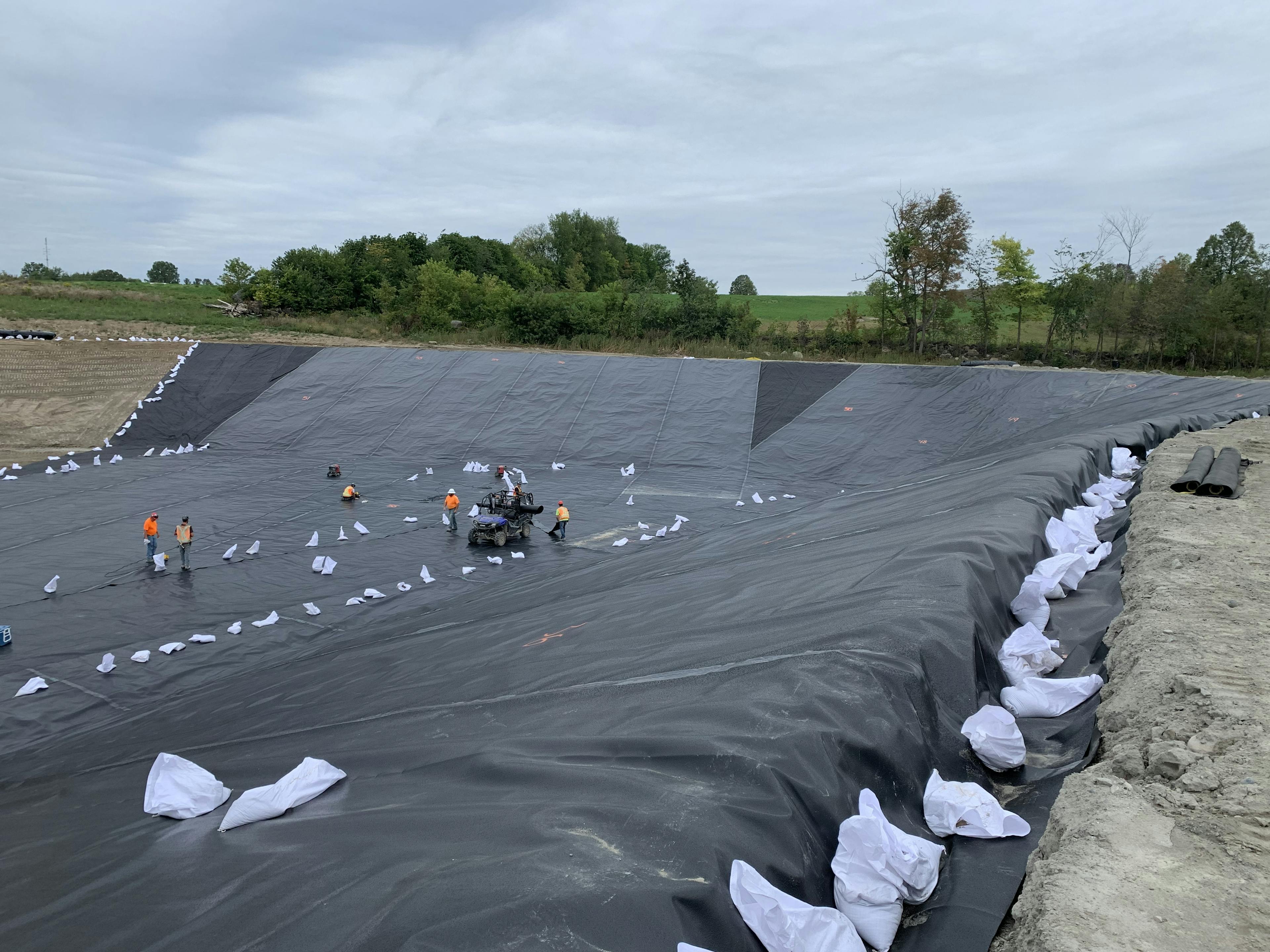Installation of Enviromax liner above 1160N Geotextile – note anchor trench in foreground