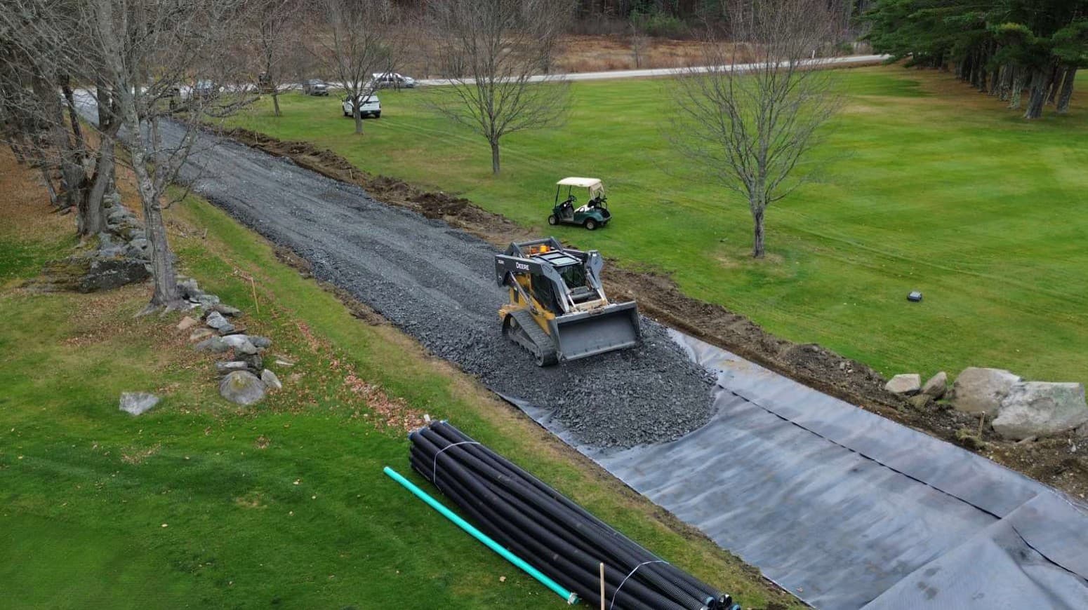 Crews placing and grading aggregate over MIRAFI® H2Ri to support drainage and raise the roadway to the proposed elevation.