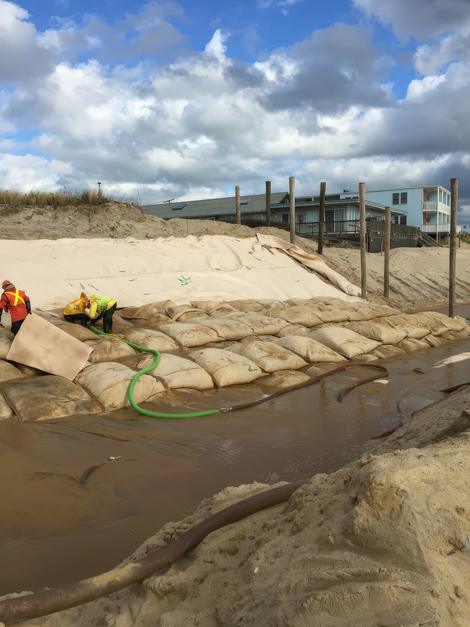 The GEOTUBE Geobag units were fabricated from a sand-colored engineered composite with high UV and abrasion resistance, and paired with matching scour aprons for shoreline integration.