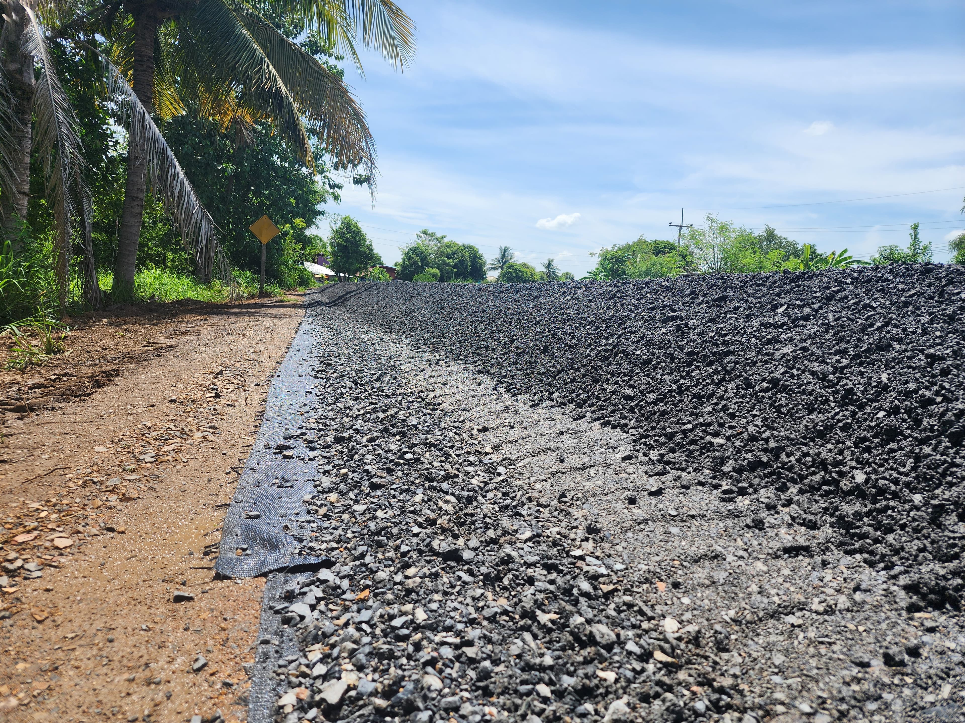 Crushed rock was placed over the geotextile as a base layer, and the final pavement surface was constructed on top