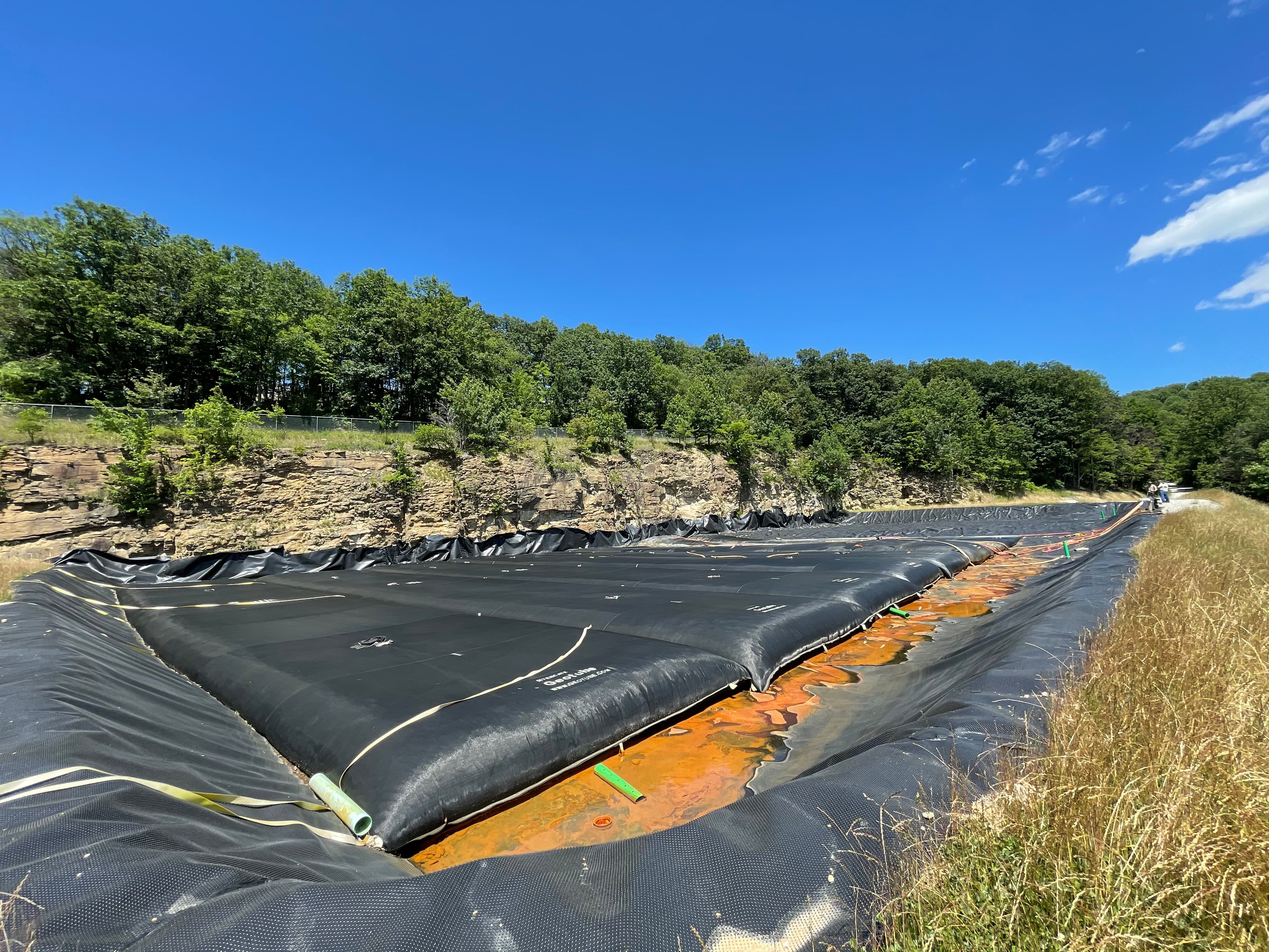Several GEOTUBE® containment systems in action, dewatering acid mine drainage.