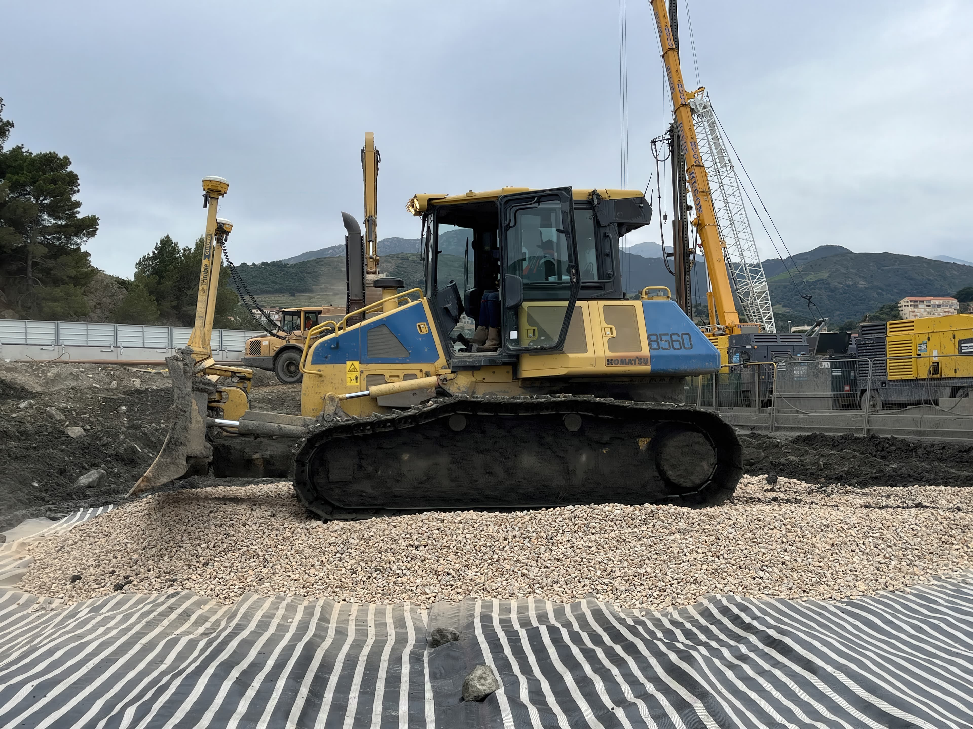 The layered system created a trafficable platform capable of supporting construction vehicles during preloading.