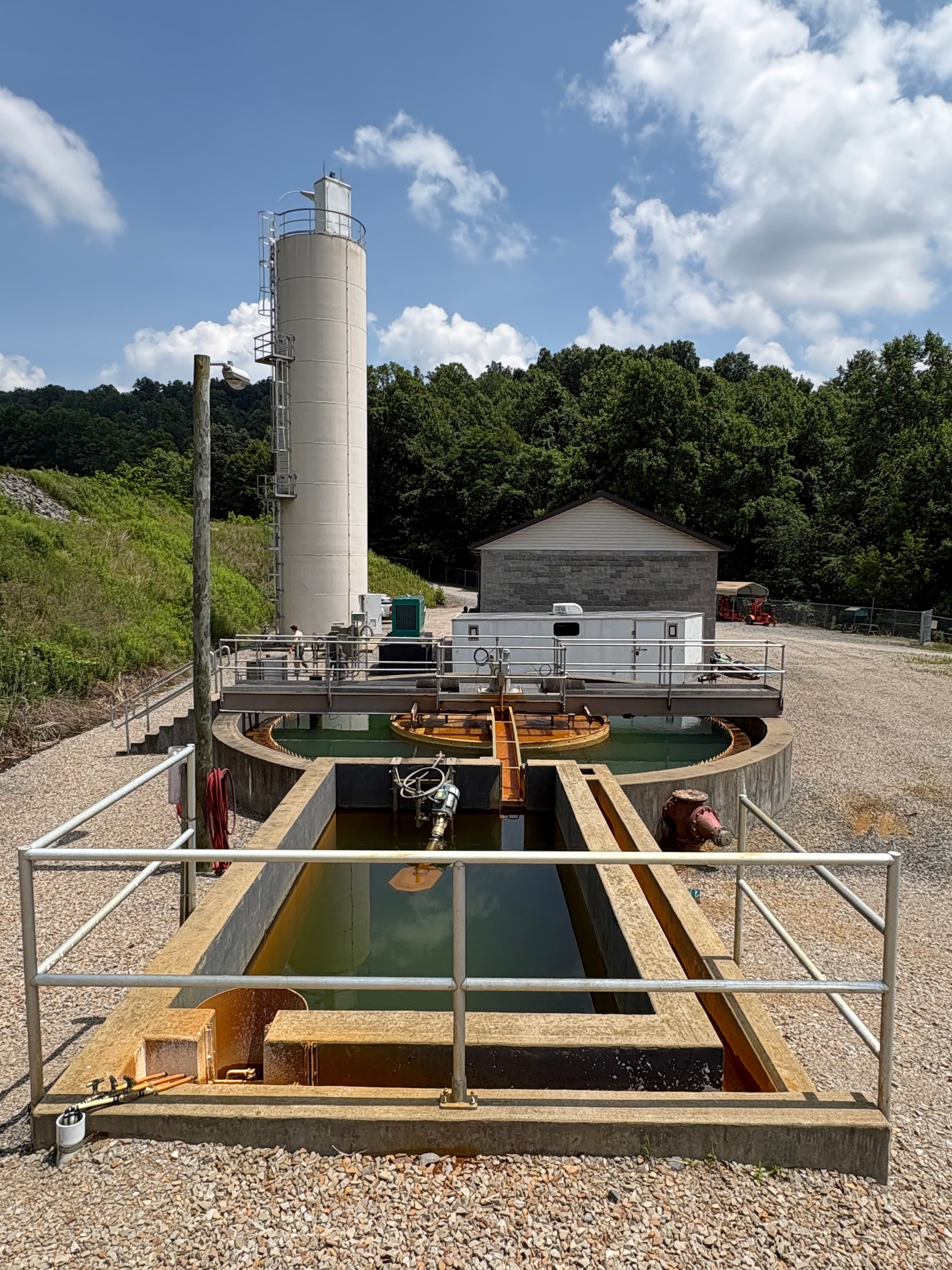 Water treatment system to separate raw AMD into treatable water and slurry.