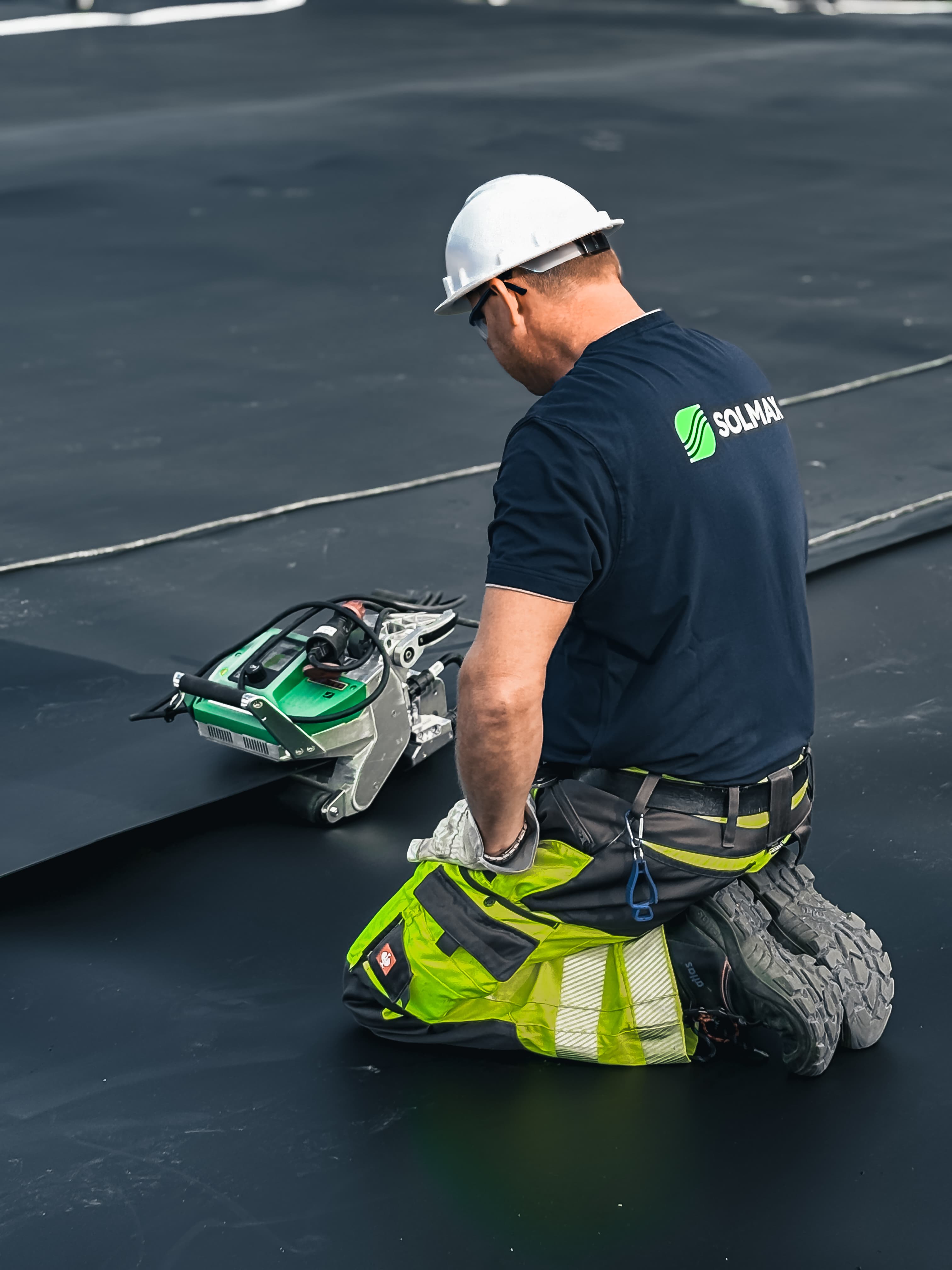 Kneeling man installing