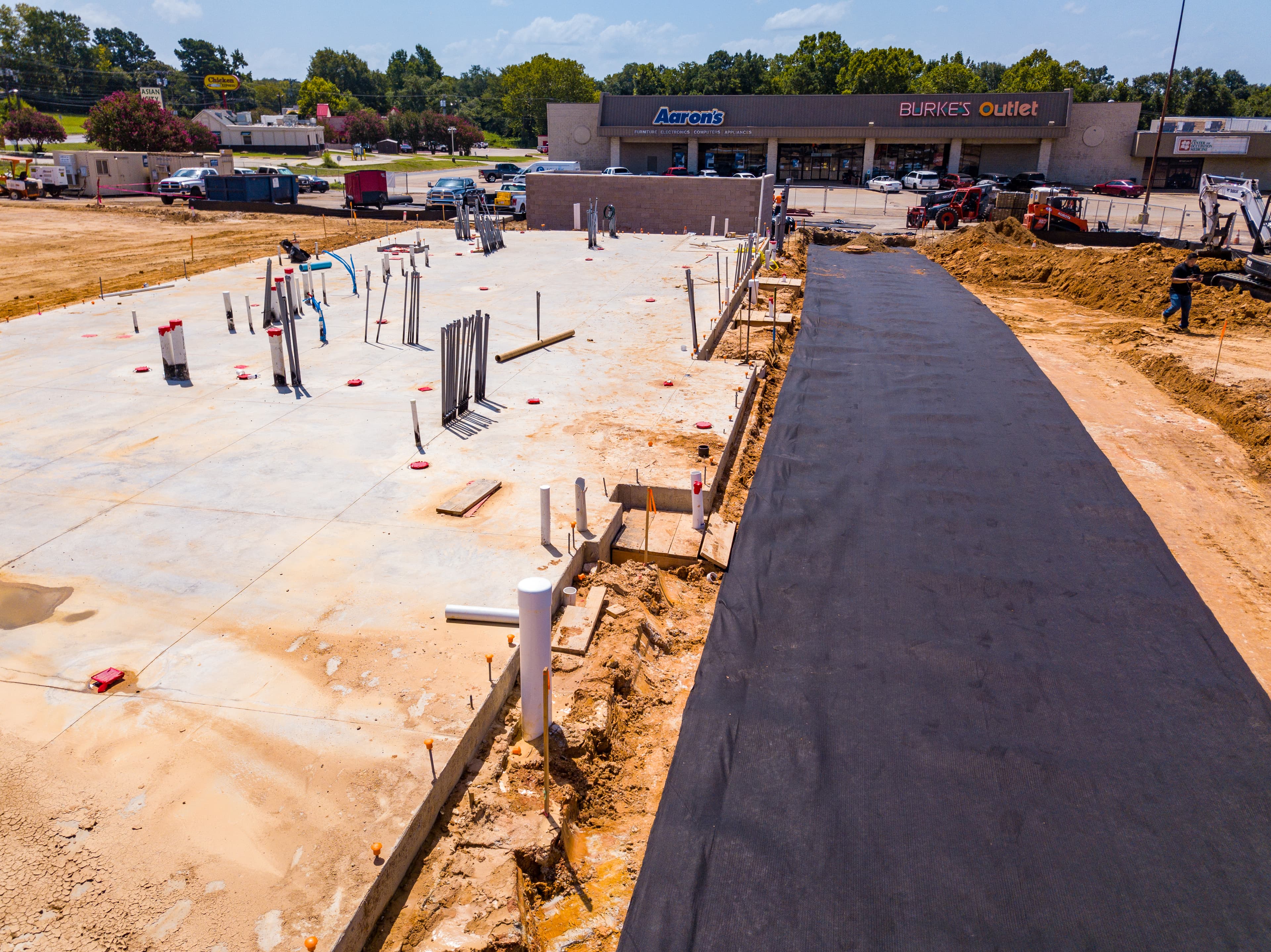 Contractors installing geocomposite drainage to replace traditional aggregate