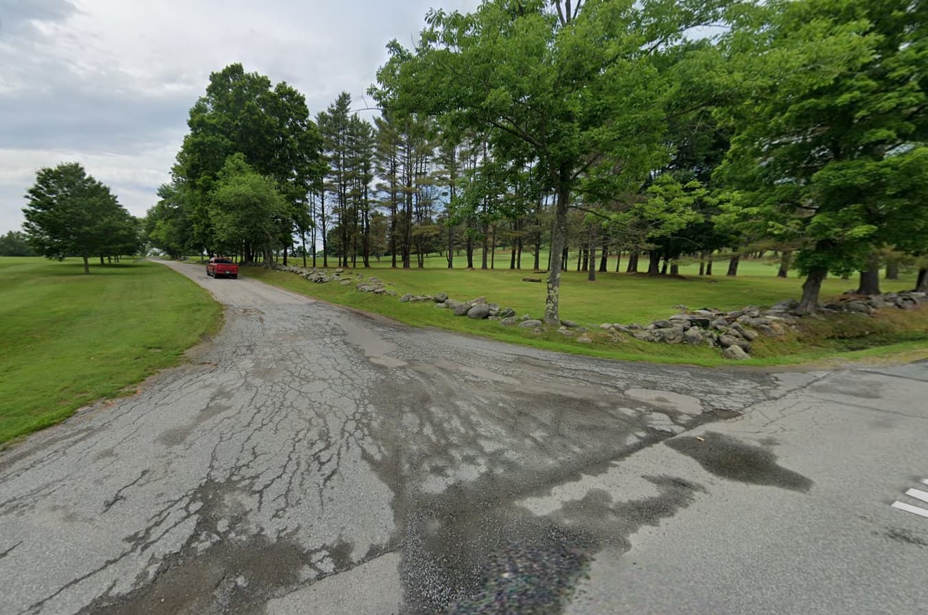 Widespread spiderweb cracking across the roadway indicated significant pavement deterioration and the need for reconstruction.