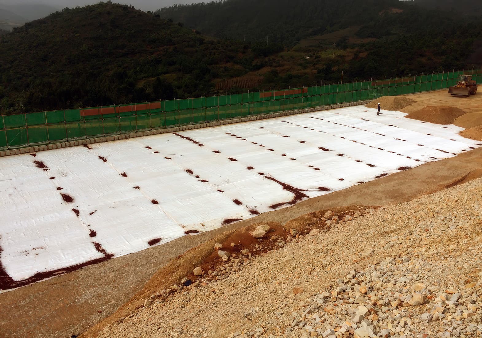 Placement of reinforced fill on top of MIRAFI