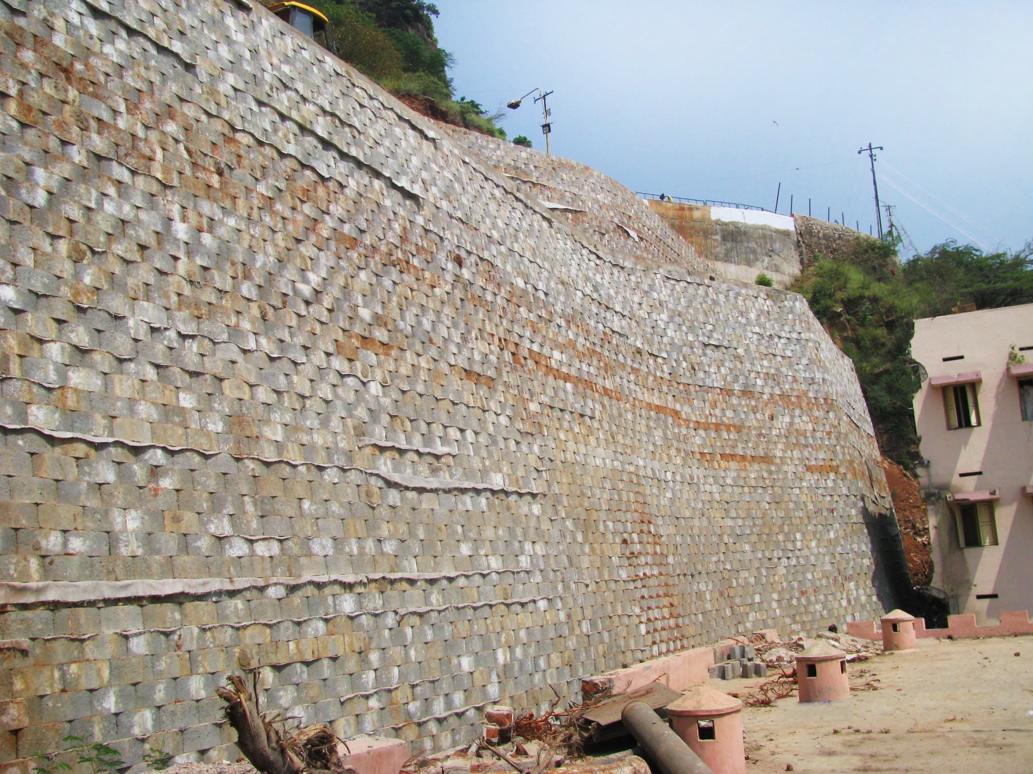 After careful analysis, it was determined that a segmental retaining wall using MIRAFI® Polyfelt® PEC was the most suitable option compared to alternatives such as building a bridge or excavating the hill.