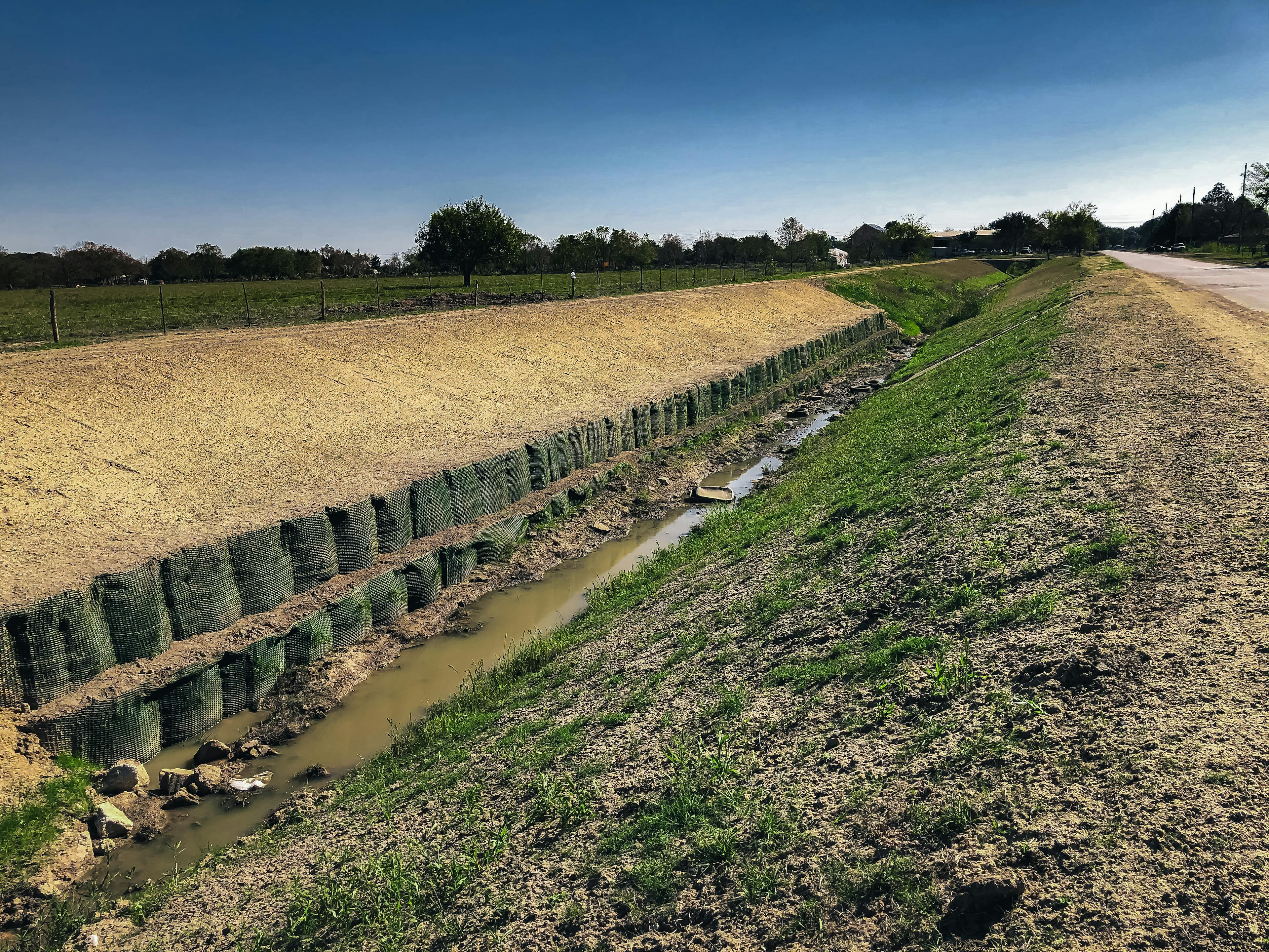 BKDD used PROPEX Scourlok for durable, environmentally-friendly erosion protection along a drainage channel in Texas, replacing gabion baskets with a long-lasting solution.