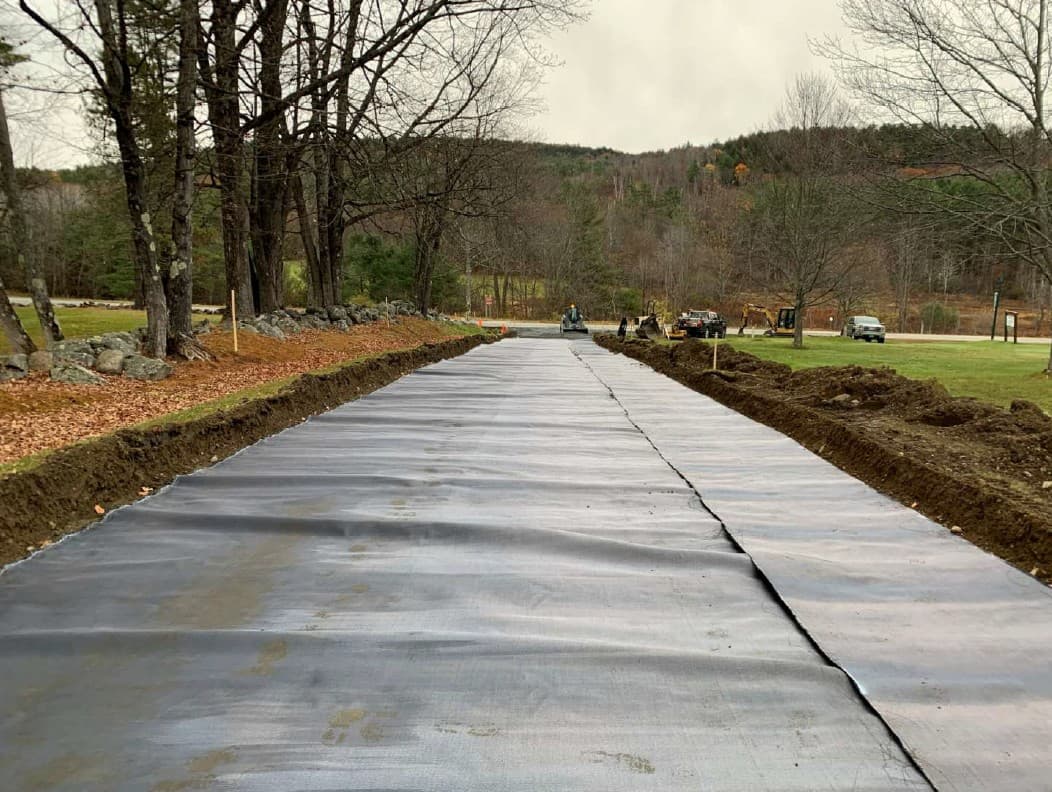 Crews completing the MIRAFI® H2Ri installation, creating a continuous layer over the subgrade.