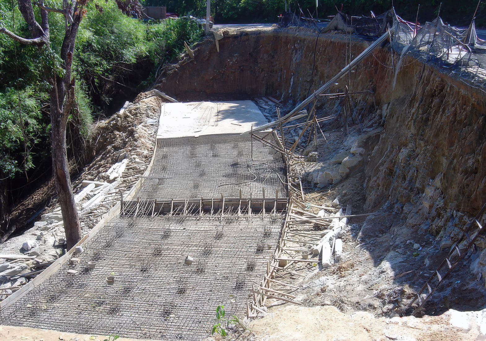 Piled concrete raft constructed as reinforced slope base