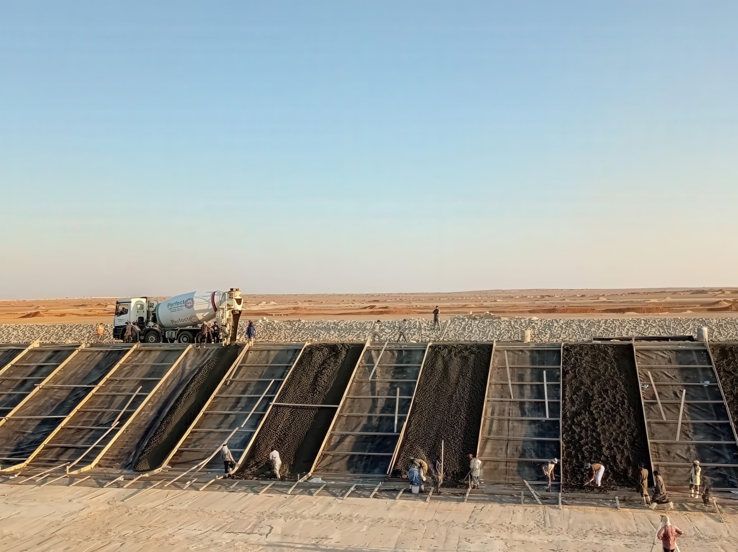 The lining system was constructed to ensure stable interaction between soil, geomembrane, and concrete layers over the canal alignment.