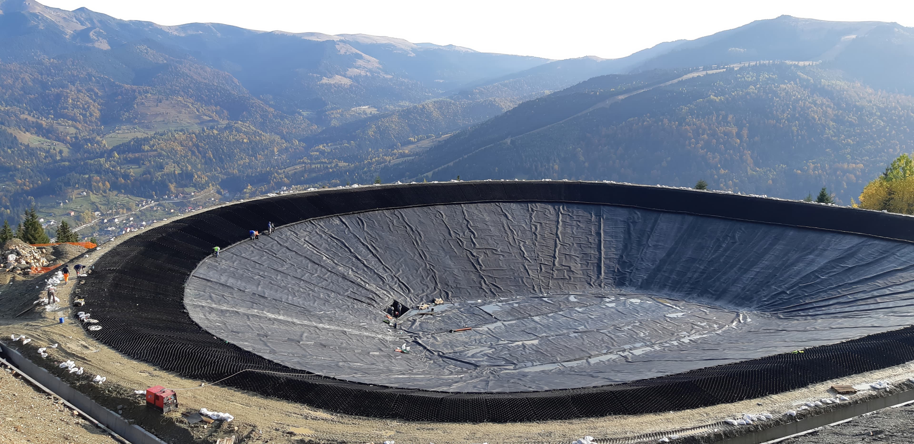 Completed Borșa artificial lake at 1,320 m altitude, providing a 22,000 m³ water reserve for snowmaking at the Olympic ski slope.