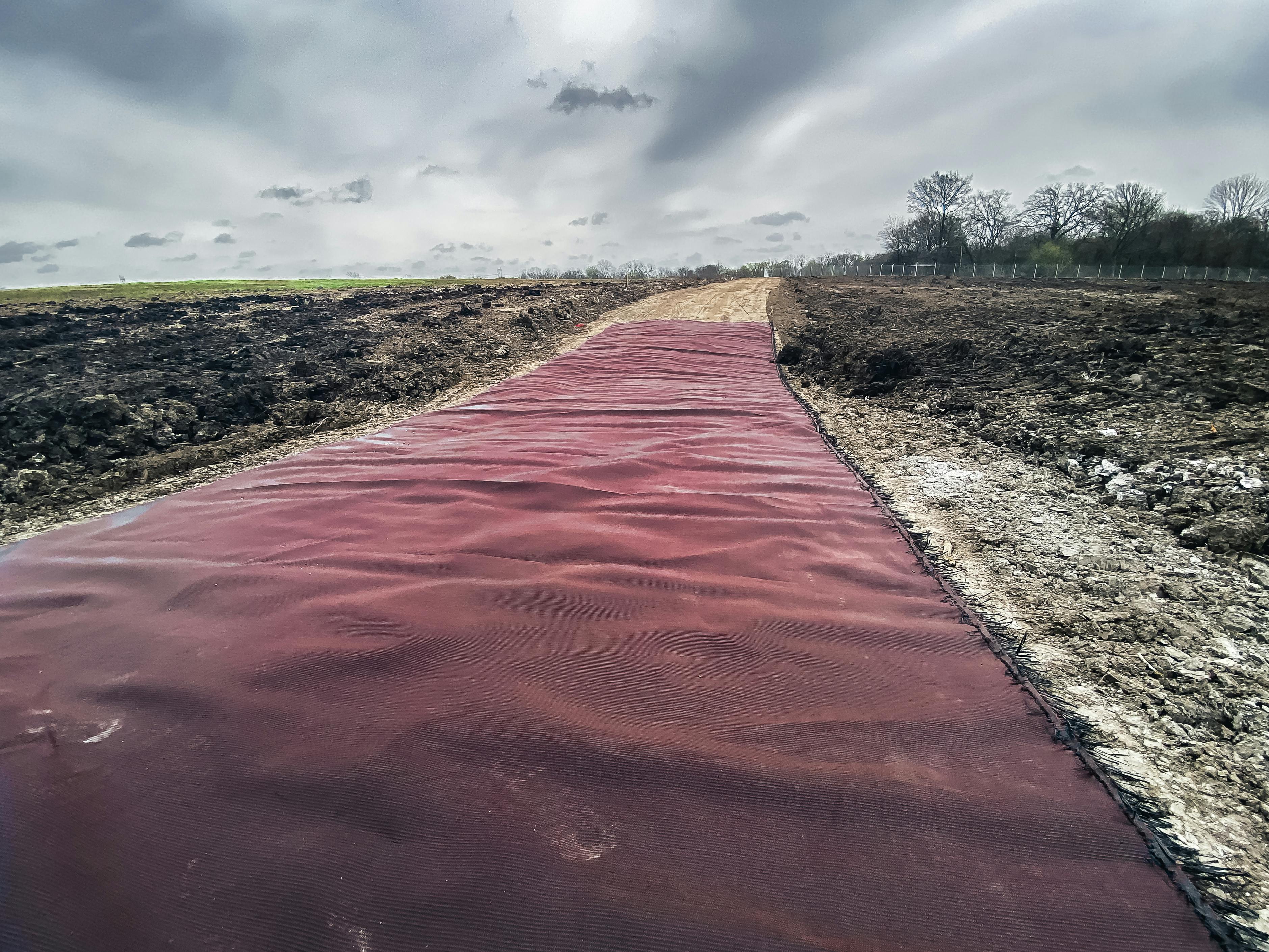 Impact Solar Farm used MIRAFI RS280i geosynthetics for road stabilization, reducing costs and CO2 emissions, and supporting heavy machinery on challenging soils. 
