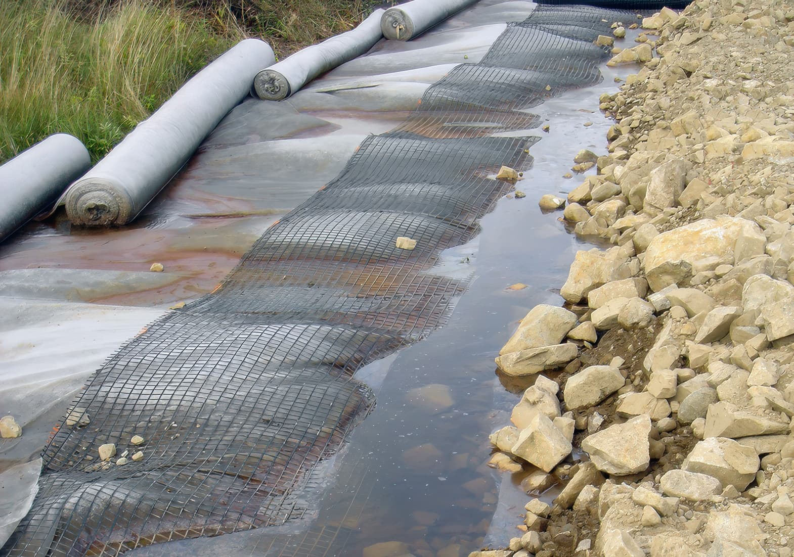 MIRAFI Polyfelt TS80 geotextile/MIRAGRID GX35-35 geogrid reinforced working platform across the peat bog
