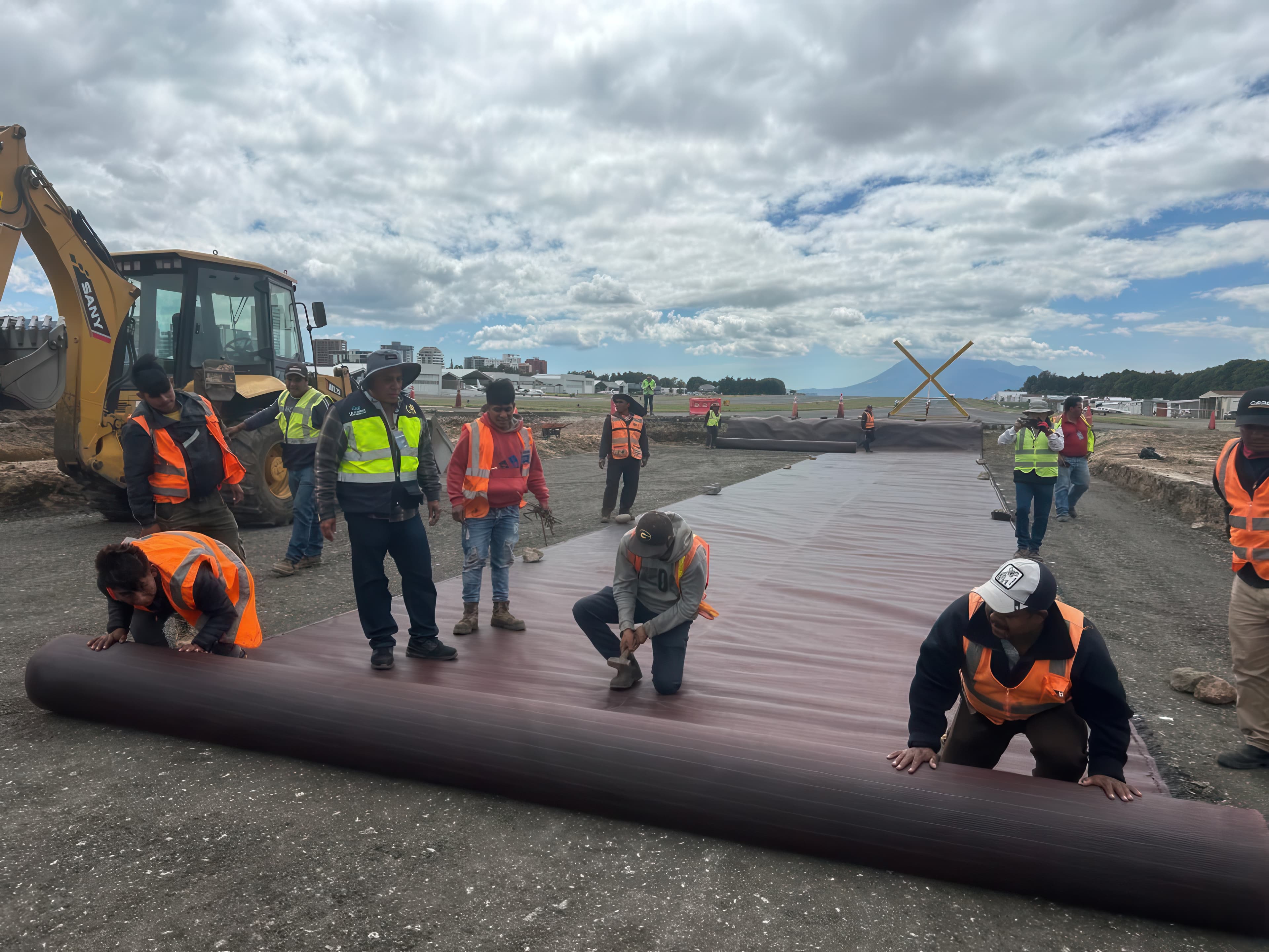A thin layer of reclaimed asphalt pavement was placed and compacted to smooth the subgrade and address localized instability prior to reinforcement.