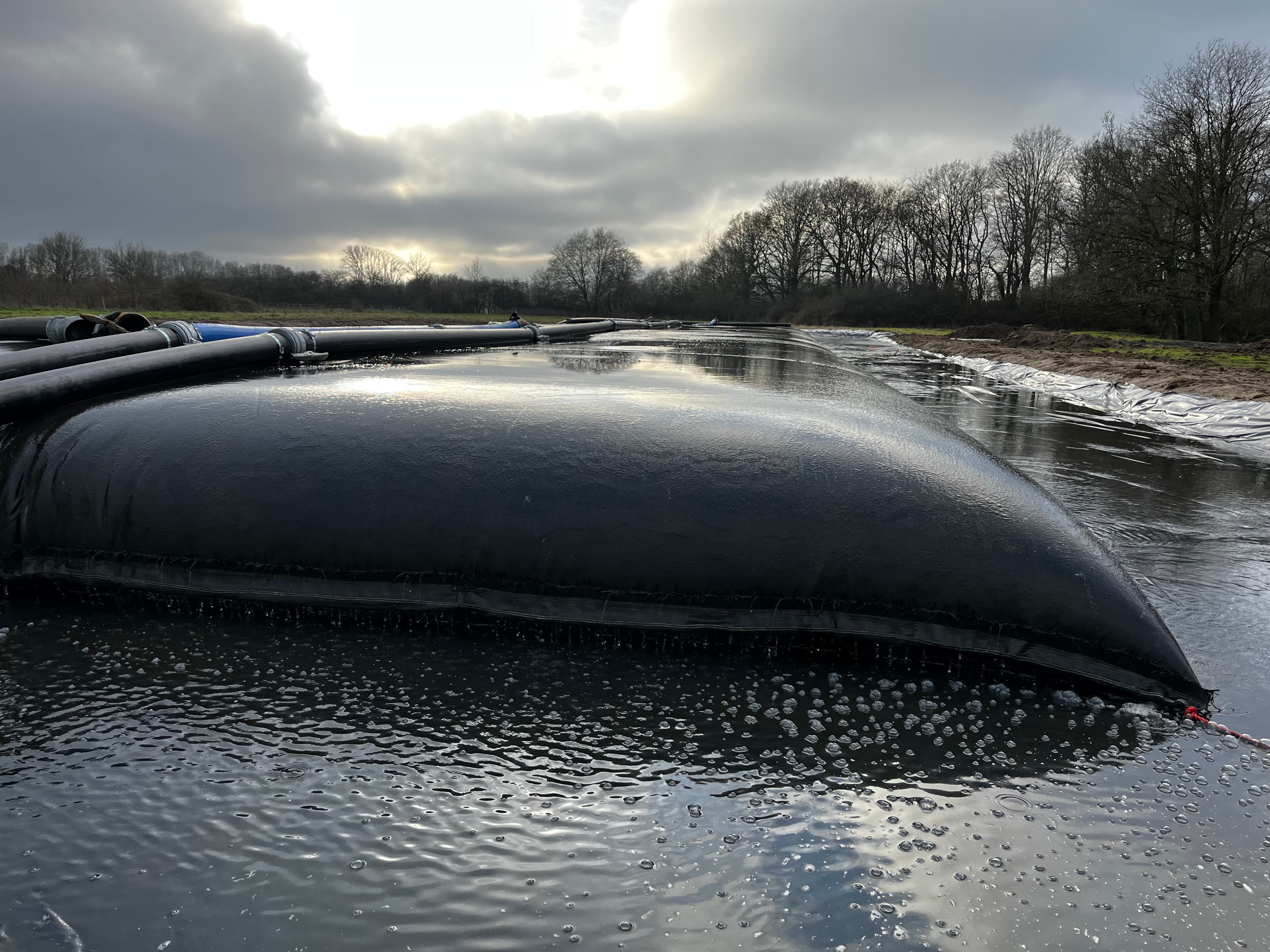 Dredged sludge was pumped directly into geotextile dewatering units with flocculant to promote solid–liquid separation.