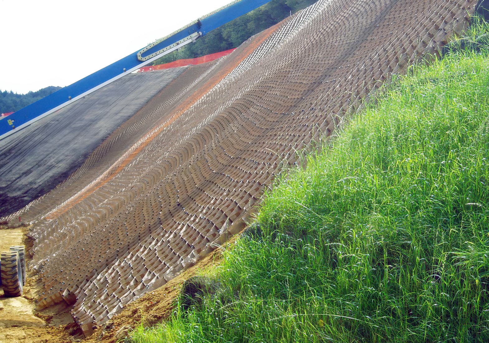 Placing geocell facing with topsoil infill