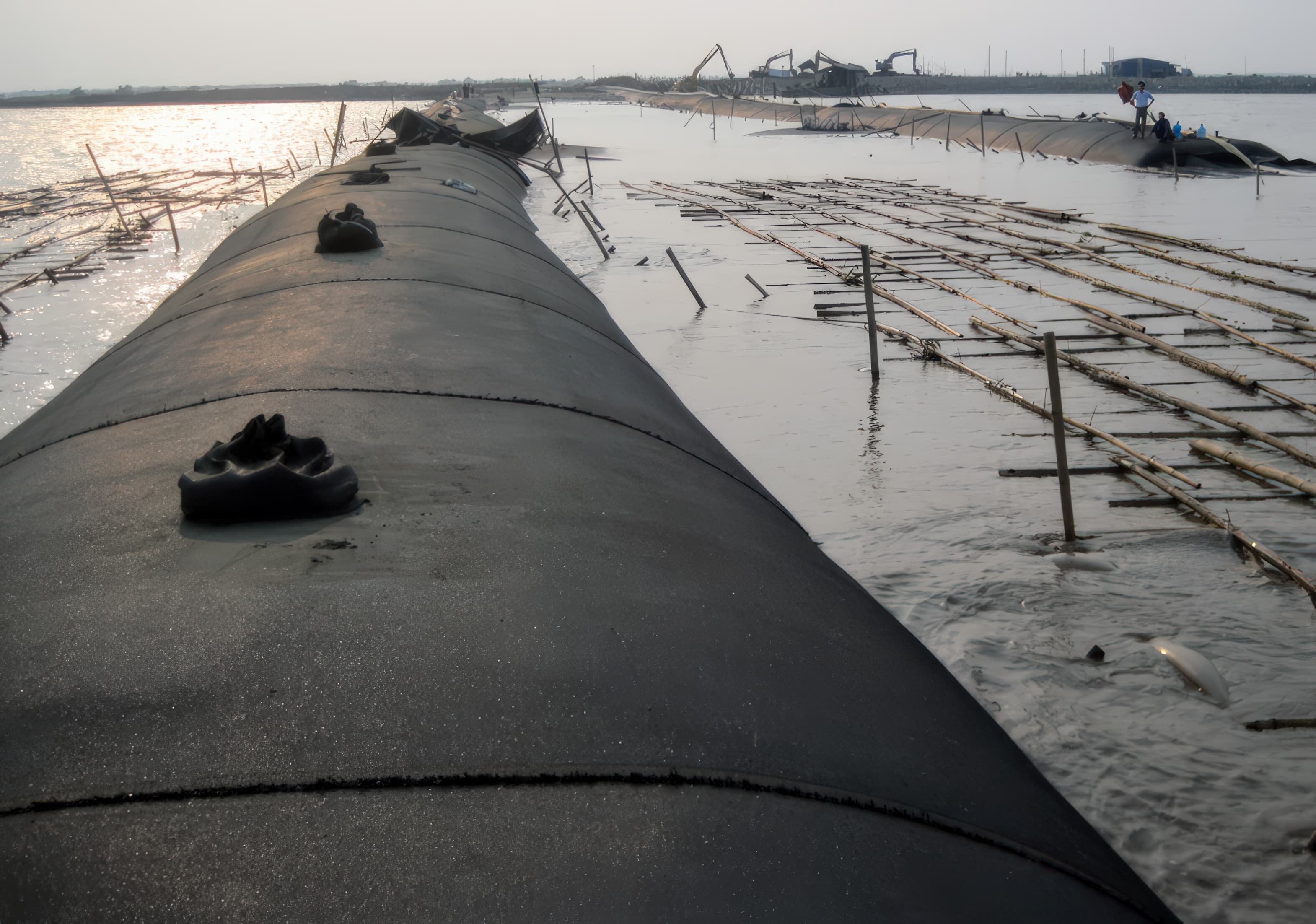 Reclamation dykes were built with GEOTUBE containment units filled with locally dredged silty sand to provide stability on very soft seabed soils.